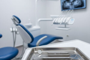 Minimalist dental clinic interior with a focus on sterile instruments on a tray, highlighting essential equipment for a new dental practice.