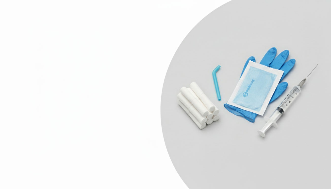 Assortment of general dental consumables including cotton rolls, suction tip, sterile gloves, and dental syringe on a clean, light background with subtle shadow.